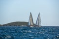 Ship yachts with white sails in the open Sea. Luxury boats.