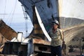 Shipbreaking Yard in Darukhana, Mumbai, India Ã¢â¬â INS Vikrant dismantling with scrap metal & workers in background Royalty Free Stock Photo