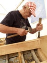 Shipbuilder works with a chisel