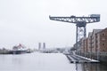 Shipbuilding crane at port dock old traditional industry with large ship on the sea