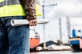 Shipbuilding engineer holding construction documents.