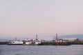 Shipbuilding port and ships at dock with crane at sunset coastal view