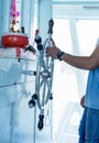 Shipmaster working on hand control on helm Royalty Free Stock Photo