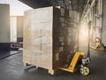 Shipment boxes, Cargo freight truck, Delivery. Hand pallet jack with stack cardboard boxes on pallet loading into cargo container. Royalty Free Stock Photo