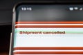 Shipment cancelled text on smart phone screen