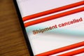 Shipment cancelled text on smart phone screen