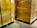 Shipment cartons box on pallets and wooden case on hand lift in interior warehouse cargo for export and sorting goods in freight Royalty Free Stock Photo
