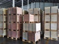 Shipment cartons box on pallets and wooden case on hand lift in interior warehouse cargo for export and sorting goods in freight l Royalty Free Stock Photo
