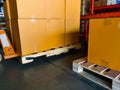 Shipment cartons box on pallets and wooden case on hand lift in interior warehouse cargo for export and sorting goods in freight Royalty Free Stock Photo