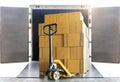 Shipment goods, Cargo freight truck, Delivery. Hand pallet jack with stack cardboard boxes on pallet loading into container truck. Royalty Free Stock Photo