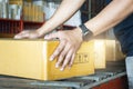 Shipment. Parcel boxes, Warehousing. Worker sorting package boxes on conveyor belt at distribution warehouse. Royalty Free Stock Photo