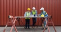 Shipment worker pointing at  shipping schedule on tablet computer, explain to colleague  about planning for next shipment.  A Royalty Free Stock Photo