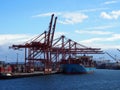 Shipping boat unloaded in Seattle harbor by cranes