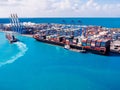 Shipping cargo port to harbor by crane. Container ship business logistics. Water International transport. Aerial top Royalty Free Stock Photo