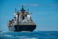 Shipping container on a Blue ocean with Blue Skies Royalty Free Stock Photo