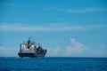 Shipping container on a Blue ocean with Blue Skies Royalty Free Stock Photo