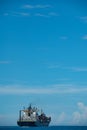 Shipping container on a Blue ocean with Blue Skies Royalty Free Stock Photo