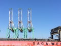 Shipping container cranes for loading ocean cargo ship vessel Royalty Free Stock Photo