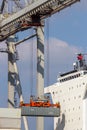 Shipping container unloaded by gantry crane from a industrial ship in the port Royalty Free Stock Photo