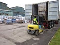 Shipping Containers Being Unloaded With Forkliift 