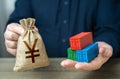 Shipping containers and chinese yuan or japanese yen money bag. Royalty Free Stock Photo