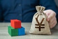 Shipping containers and chinese yuan or japanese yen money bag. Royalty Free Stock Photo