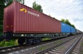 Shipping containers of `Honeytak Intermodal Limited` transportation on cargo train by railway. China-Europe freight trains