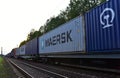 Shipping containers of `MAERSK SHIPPING` transport on cargo train by railway. China-Europe freight trains. Object in motion, sof
