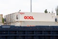 Shipping containers OOCL brand are waiting for loading. International transport. Concept of export and import by ships