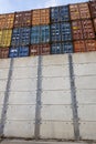 Shipping containers viewed over a security wall at Southampton, UK