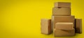 Shipping and delivery - blank cardboard boxes on yellow background with copy space Royalty Free Stock Photo