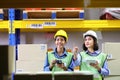 Shipping industry female workers wearing safety vest working in warehouse checking for the inventory Royalty Free Stock Photo