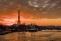 Ships and brigde over Seine river with Eiffel tower in background and dramatic cloudy sky