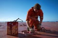 Ships crew members painting hatch cover outdoors with bright blue sky on a background. Ship maintenance concept