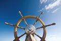 ships helm against a blue sky