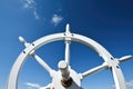 ships helm against a blue sky