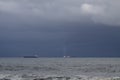 Ships on the horizon against rainy sky Royalty Free Stock Photo