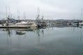 Dramatic image of a marina with boats in Bodega Bay, California. With water reflections. Royalty Free Stock Photo