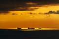 Ships at sea, silhouettes of ships at sea against a bright sunset sky, sunlight reflected from the waves, dramatic sky Royalty Free Stock Photo