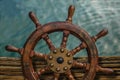 Ships Wheel Against Ocean Water Royalty Free Stock Photo