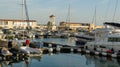Ships, yachts and boats on blue surface of Black Sea by pier of Commercial seaport of Sochi. Resort city center. Sochi