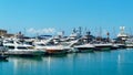 Ships, yachts and boats on blue surface of Black Sea by pier of Commercial seaport of Sochi. Resort city center Royalty Free Stock Photo