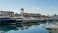 Ships, yachts and boats on blue surface of Black Sea by pier of Commercial seaport of Sochi.