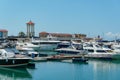 Ships, yachts and boats on blue surface of Black Sea by pier of Commercial seaport of Sochi. Royalty Free Stock Photo