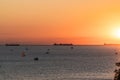 Ships, yachts and pleasure boats on the horizon during sunset in the Black Sea.