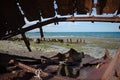 Rusty metal remains of hull of ship on coastline Atlantic Ocean