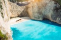 Shipwreck on Navagio beach with turquoise blue sea water surrounded by huge white cliffs. Famous landmark location on Royalty Free Stock Photo