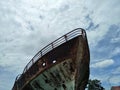 Shipwreck at the riverside in the cloudy day. Royalty Free Stock Photo