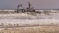 A shipwreck stranded on the beach in the Atlantic Ocean in the Skeleton Coast National Park in Namibia Royalty Free Stock Photo