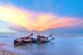 Shipwreck or wrecked boat on beach in the sunset. Beautiful Landscape.